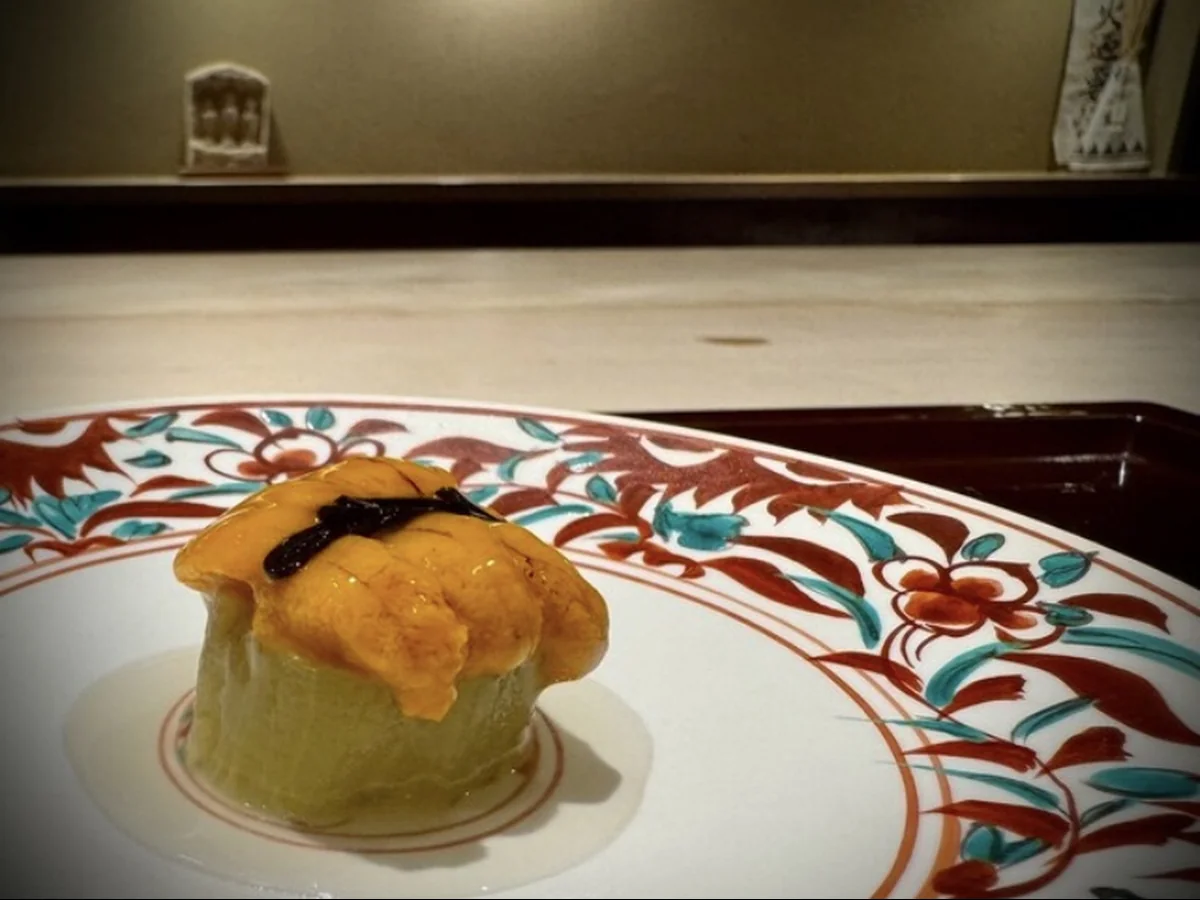 Sea urchin-topped dish on a floral-patterned plate