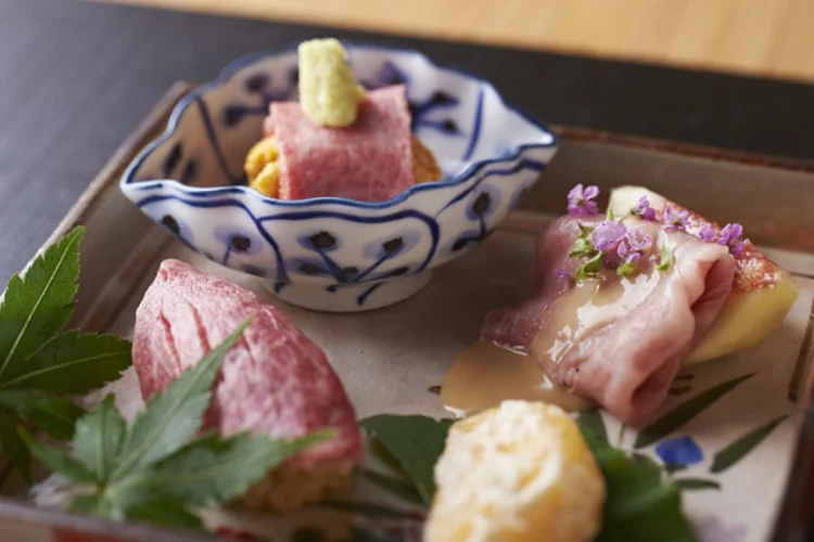 Small pink-centered slices and garnishes arranged on a ceramic platter