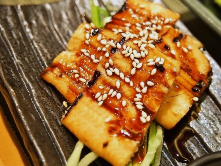 Grilled conger eel glazed with sweet sauce and sesame seeds